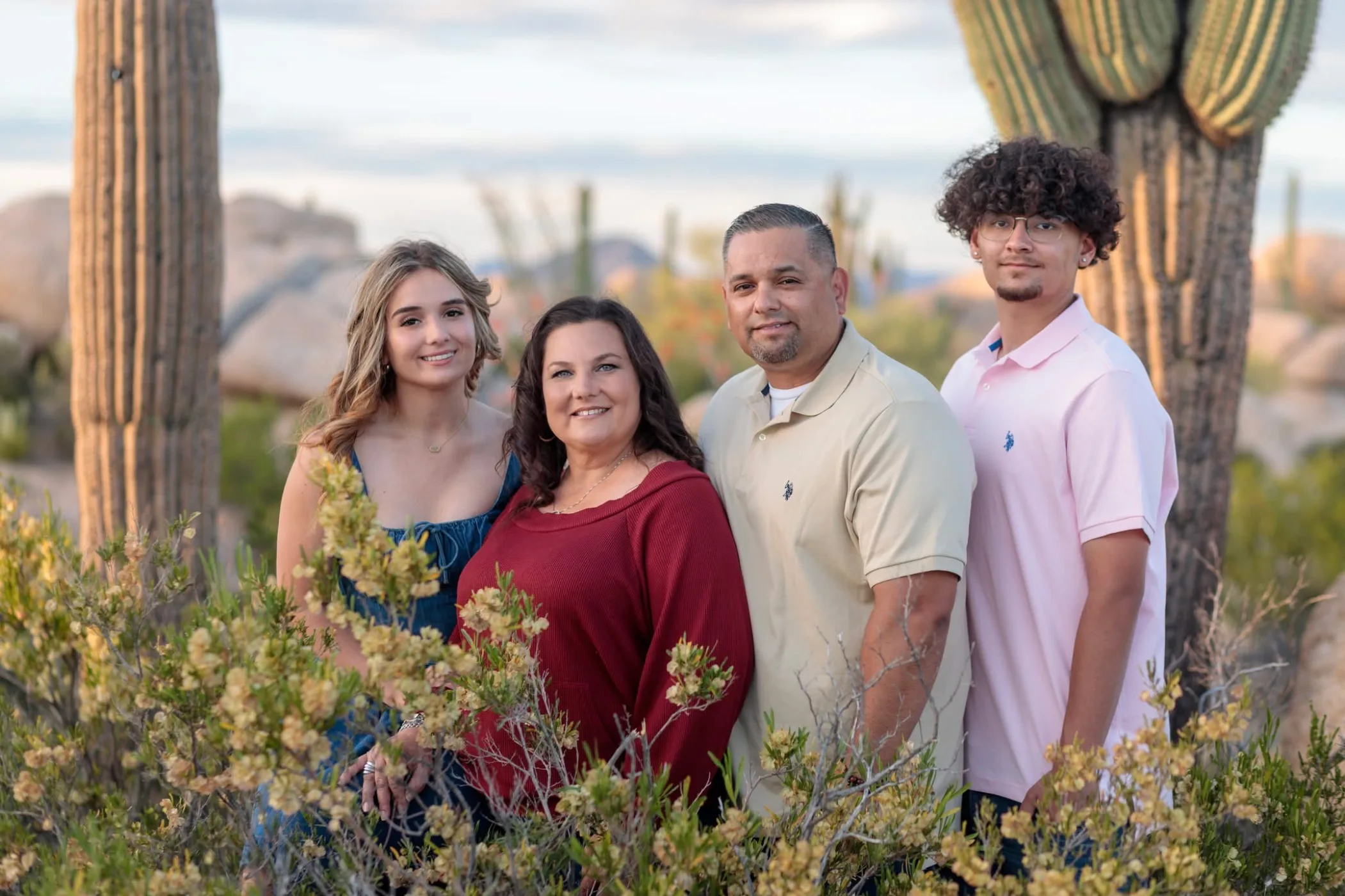 Family of four photographed at sunset among saguaros and desert brush near Florence, Arizona, by Casa de Baca Studios