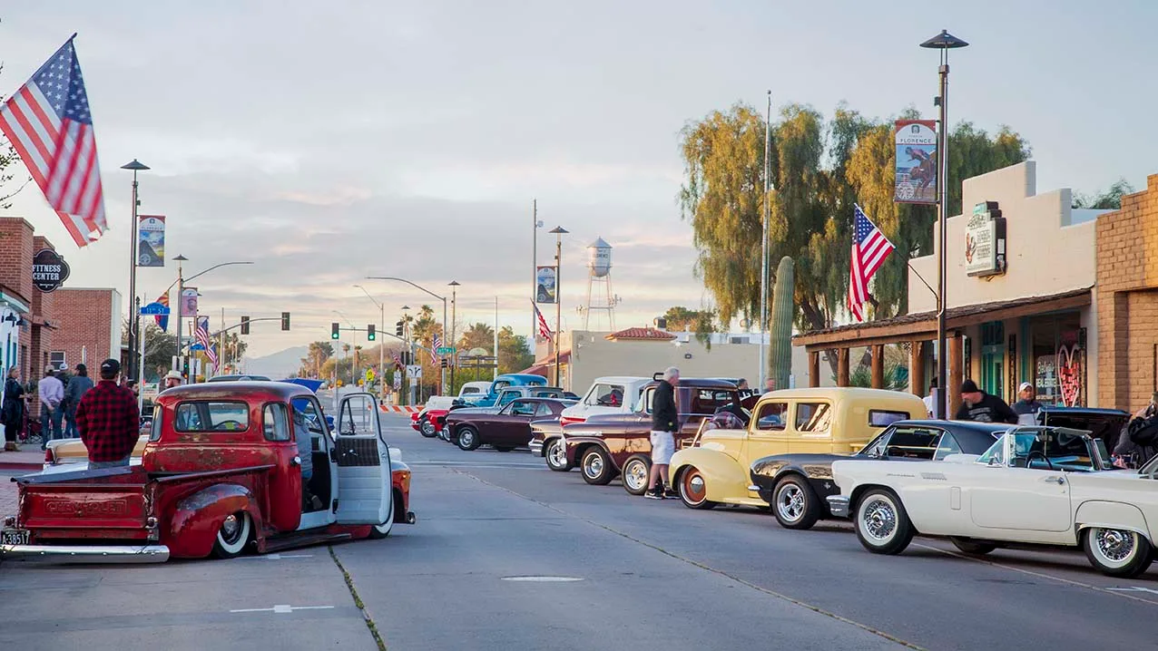 2023 Florence Car Show with water tower, vehicles, a fine art photograph by Janell Evelyn Baca