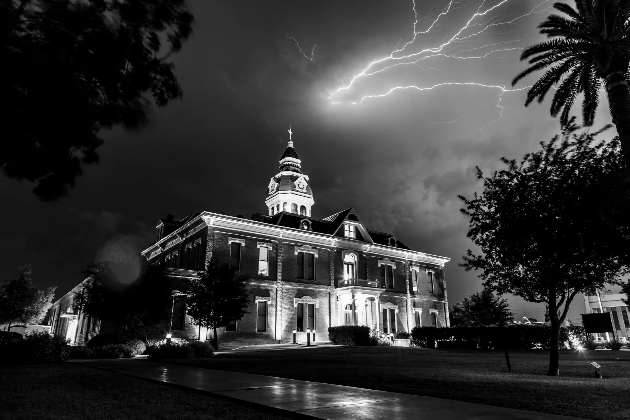 B&W Pinal County Courthouse Florence AZ, lightning, a fine art photograph by Michael Joseph Baca