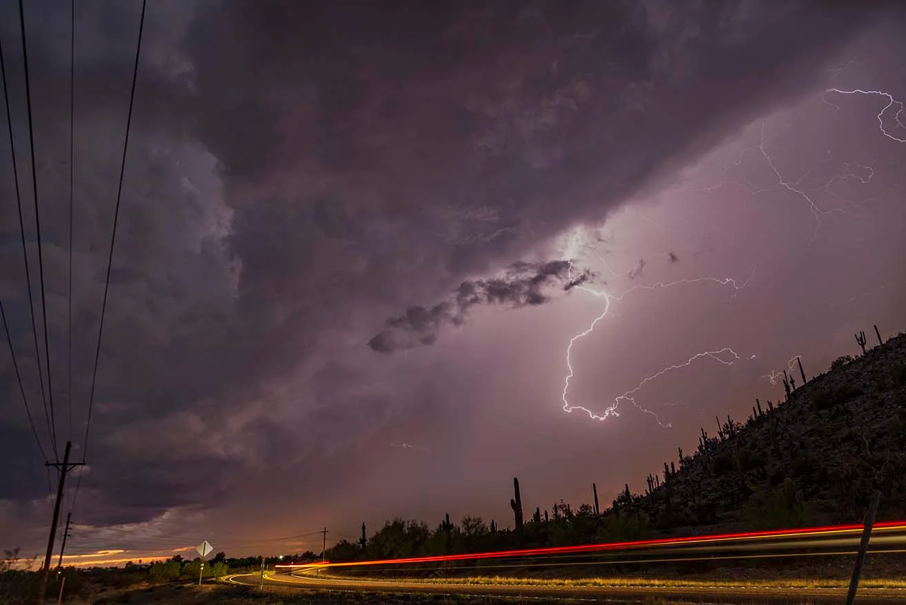 Casa Grande Lightning with carlight streaks red, a fine art photograph by Janell Evelyn Baca