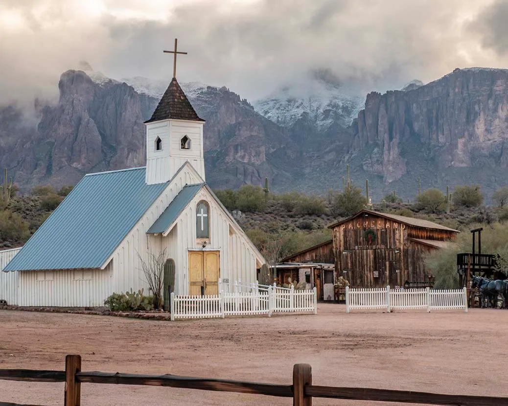 Cloud-covered Superstitions at the Elvis Chapel, snow, a fine art photograph by Janell Evelyn Baca