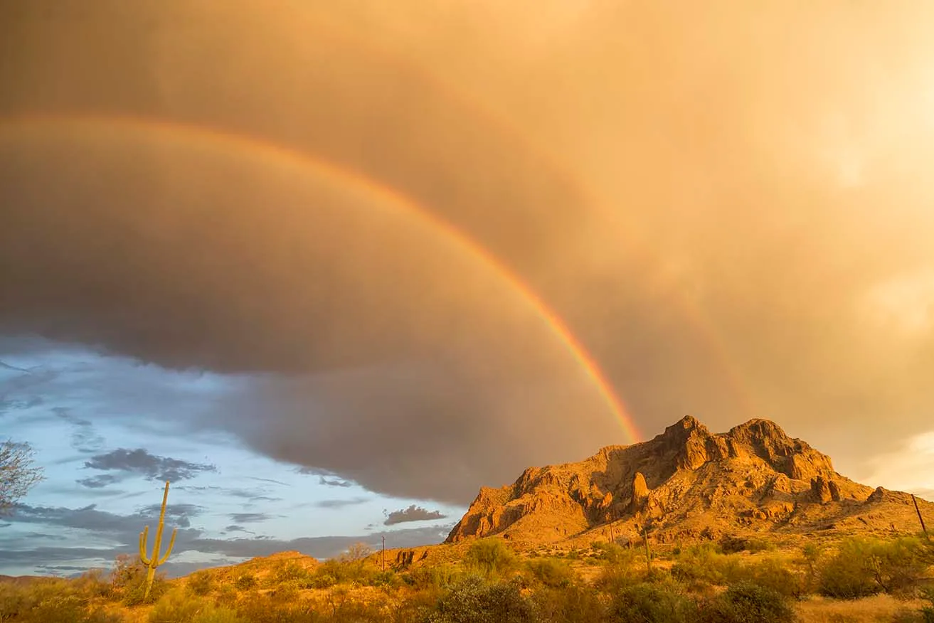 Picket Post with Rainbow and saguaro, lightning, a fine art photograph by Janell Evelyn Baca